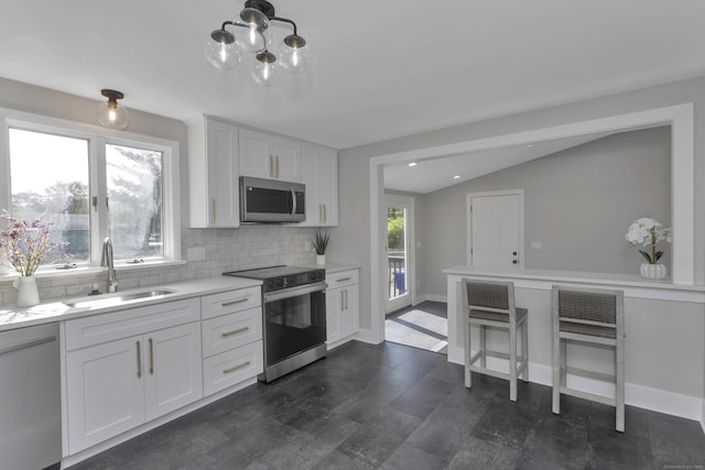 37 Litchfield Dr, Enfield, CT 06082 - kitchen with appliances with stainless steel finishes, a sink, tasteful backsplash, light countertops, and white cabinets
