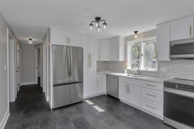 37 Litchfield Dr, Enfield, CT 06082 - kitchen featuring stainless steel appliances, a sink, light countertops, backsplash, and white cabinets