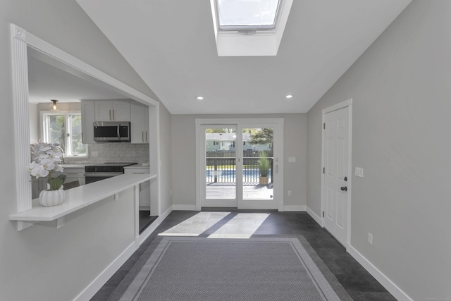 37 Litchfield Dr, Enfield, CT 06082 - kitchen featuring appliances with stainless steel finishes, lofted ceiling, a skylight, light countertops, and healthy amount of natural light