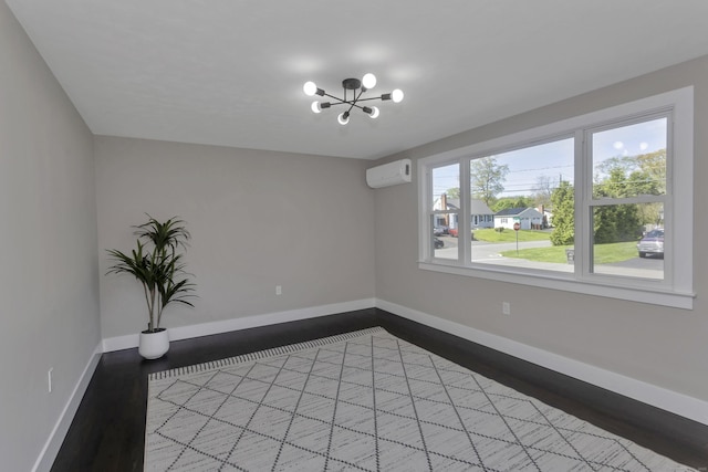 37 Litchfield Dr, Enfield, CT 06082 - unfurnished room with wood finished floors, baseboards, a chandelier, and a wall unit AC
