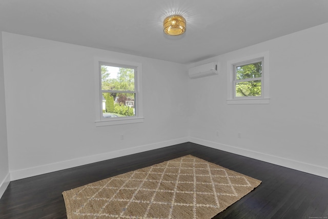 37 Litchfield Dr, Enfield, CT 06082 - unfurnished room featuring baseboards, a wall mounted AC, and dark wood-type flooring