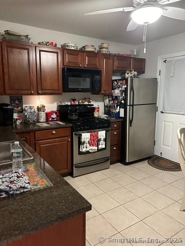 663 W Ave Unit A21, Milford, CT 06461 - kitchen featuring appliances with stainless steel finishes, a ceiling fan, light tile patterned flooring, and a sink