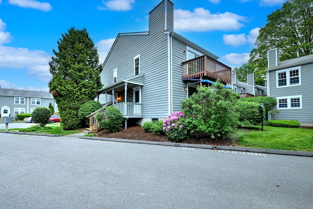 107 Ferry Ct Unit 107, Stratford, CT 06615 - view of property exterior featuring a chimney and a yard