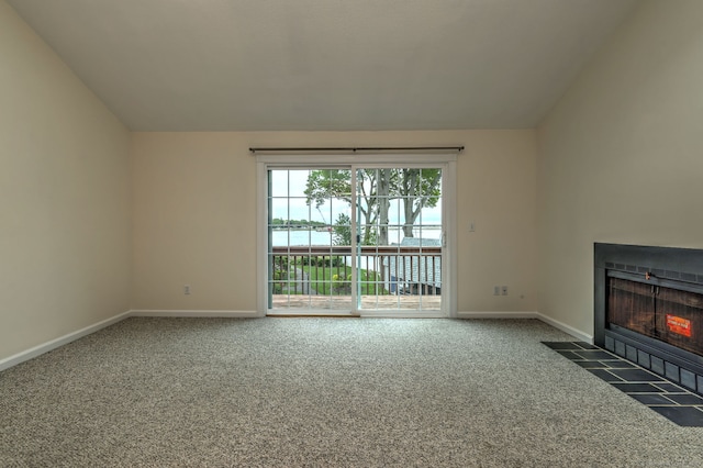 107 Ferry Ct Unit 107, Stratford, CT 06615 - unfurnished living room featuring carpet flooring, lofted ceiling, baseboards, and a fireplace