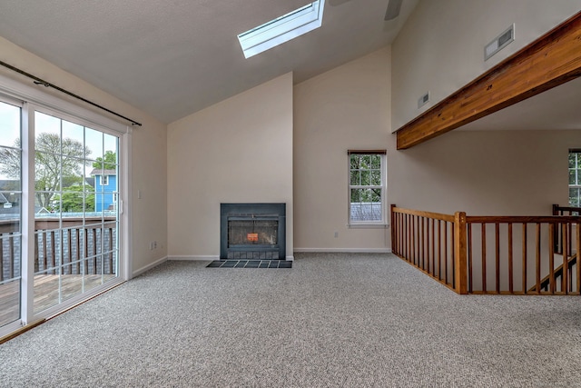 107 Ferry Ct Unit 107, Stratford, CT 06615 - unfurnished living room with carpet flooring, a skylight, a fireplace with flush hearth, baseboards, and high vaulted ceiling
