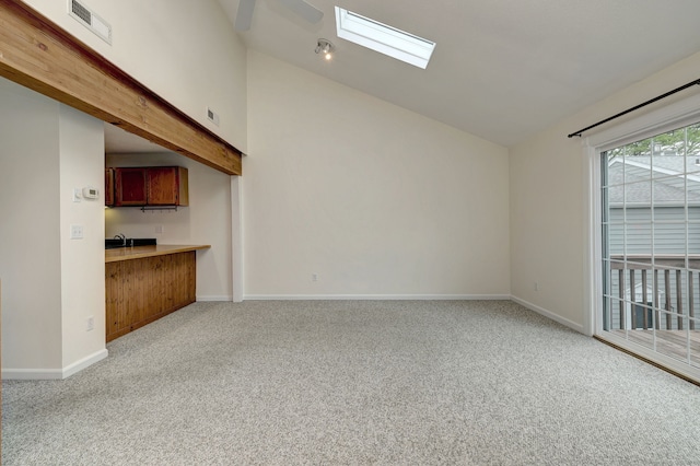 107 Ferry Ct Unit 107, Stratford, CT 06615 - unfurnished living room featuring light colored carpet, a skylight, vaulted ceiling, and baseboards