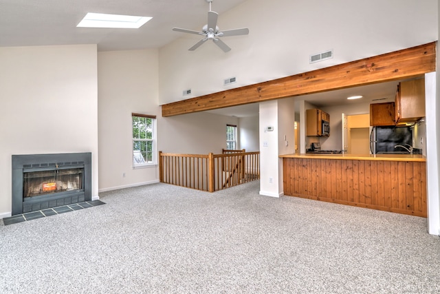 107 Ferry Ct Unit 107, Stratford, CT 06615 - unfurnished living room featuring a skylight, high vaulted ceiling, carpet floors, ceiling fan, and a fireplace with flush hearth