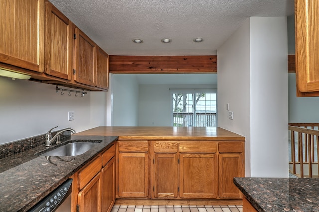 107 Ferry Ct Unit 107, Stratford, CT 06615 - kitchen featuring a sink, stainless steel dishwasher, brown cabinets, recessed lighting, and dark stone countertops