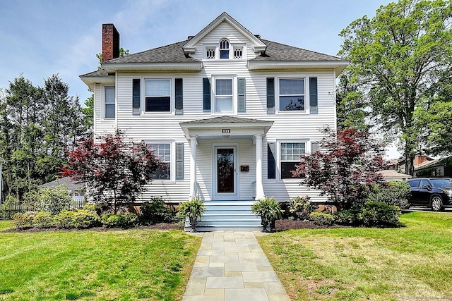 59 Golf St, Newington, CT 06111 - view of front of house featuring a chimney, a front yard, and a shingled roof