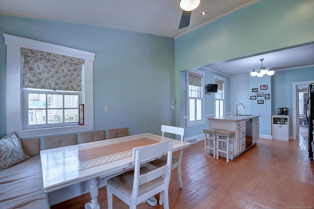 59 Golf St, Newington, CT 06111 - dining area with healthy amount of natural light, a ceiling fan, light wood-style flooring, crown molding, and a chandelier