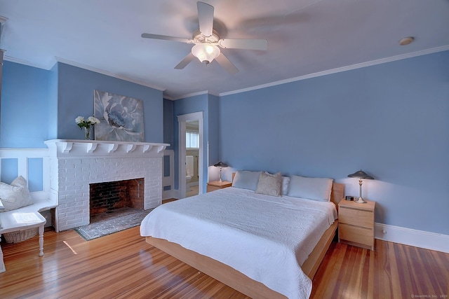 59 Golf St, Newington, CT 06111 - bedroom with wood finished floors, a fireplace, ornamental molding, a ceiling fan, and baseboards