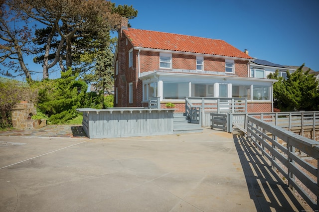28 Morgan Ter, East Haven, CT 06512 - rear view of property with brick siding, a tiled roof, and a chimney