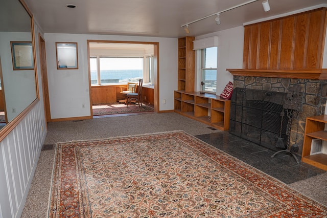 28 Morgan Ter, East Haven, CT 06512 - living area with a stone fireplace, baseboards, and rail lighting