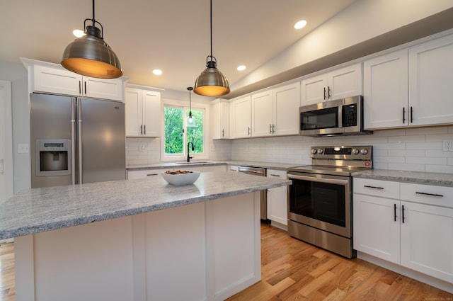 62 Wheeler Hill Dr, Durham, CT 06422 - kitchen with appliances with stainless steel finishes, light wood-type flooring, a sink, white cabinets, and decorative backsplash
