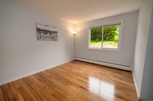62 Wheeler Hill Dr, Durham, CT 06422 - unfurnished room with baseboard heating, light wood-style flooring, and baseboards