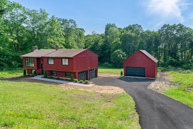 62 Wheeler Hill Dr, Durham, CT 06422 - view of property exterior with a detached garage, a chimney, a yard, and an outbuilding