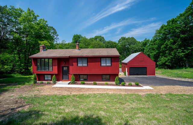62 Wheeler Hill Dr, Durham, CT 06422 - bi-level home featuring a chimney, an outdoor structure, a garage, and a front yard