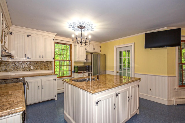 440 Mapleton Ave, Suffield, CT 06078 - kitchen featuring a sink, a wainscoted wall, stainless steel appliances, white cabinetry, and light stone countertops