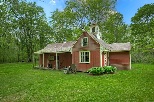 440 Mapleton Ave, Suffield, CT 06078 - back of house featuring a lawn, roof with shingles, and an outdoor structure