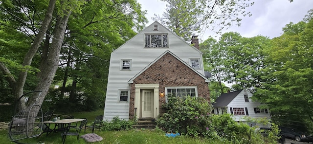 230 Winsted Rd, Torrington, CT 06790 - view of front of property featuring entry steps, a chimney, and brick siding
