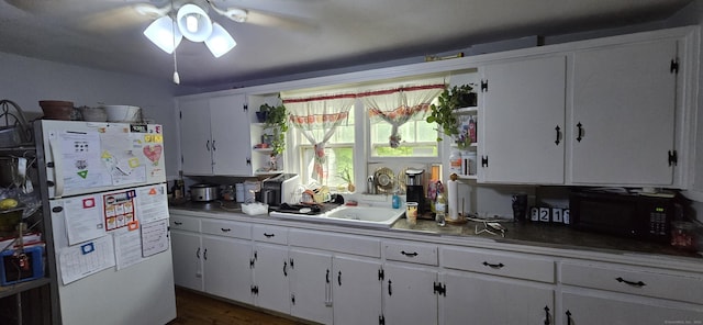 230 Winsted Rd, Torrington, CT 06790 - kitchen featuring freestanding refrigerator, black microwave, open shelves, and a ceiling fan