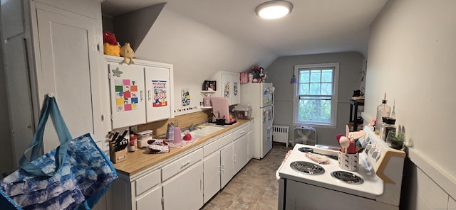 230 Winsted Rd, Torrington, CT 06790 - kitchen with radiator, white appliances, light countertops, white cabinetry, and lofted ceiling