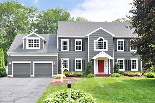 151 Oakridge, Farmington, CT 06085 - colonial-style house featuring driveway, a front lawn, roof with shingles, and a garage