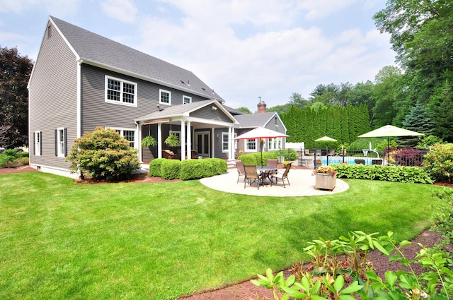 151 Oakridge, Farmington, CT 06085 - back of property with a patio area, a yard, and roof with shingles