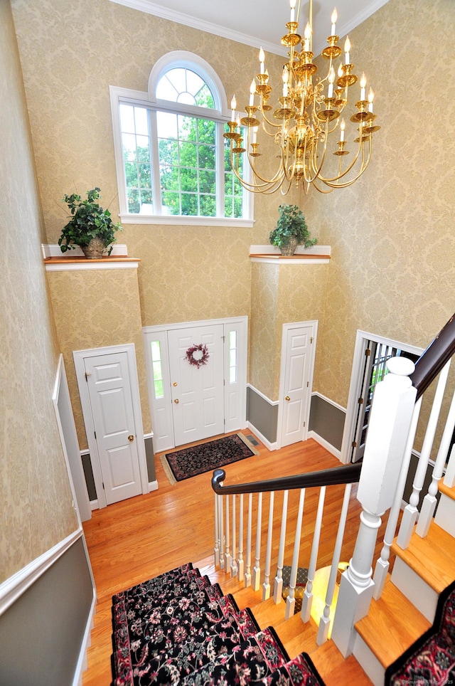 151 Oakridge, Farmington, CT 06085 - entryway featuring wood finished floors, a chandelier, stairway, and crown molding