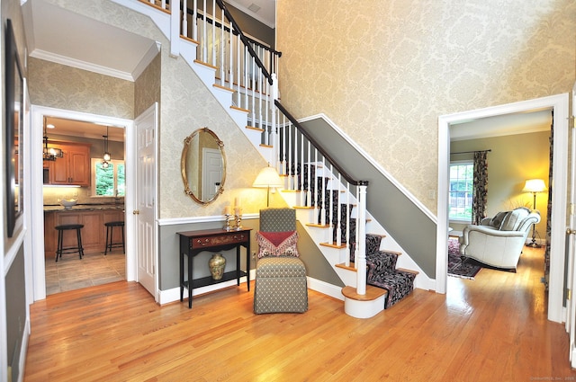 151 Oakridge, Farmington, CT 06085 - stairs featuring wood finished floors, wallpapered walls, ornamental molding, and a towering ceiling