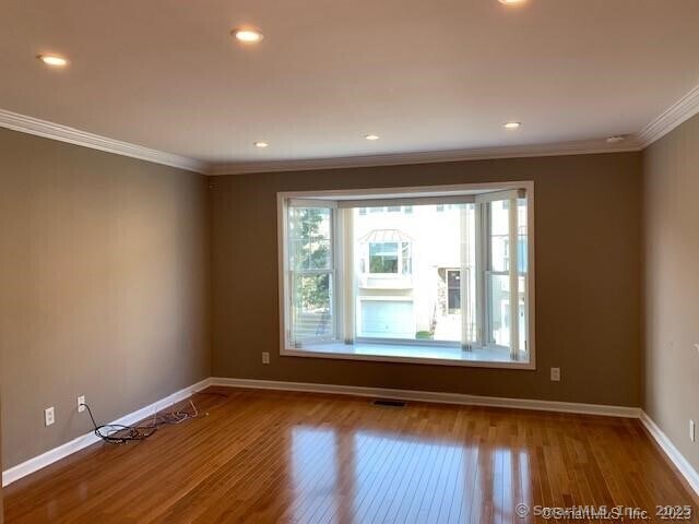 15 Scuppo Rd Unit 402, Danbury, CT 06811 - empty room with crown molding, baseboards, wood finished floors, and recessed lighting