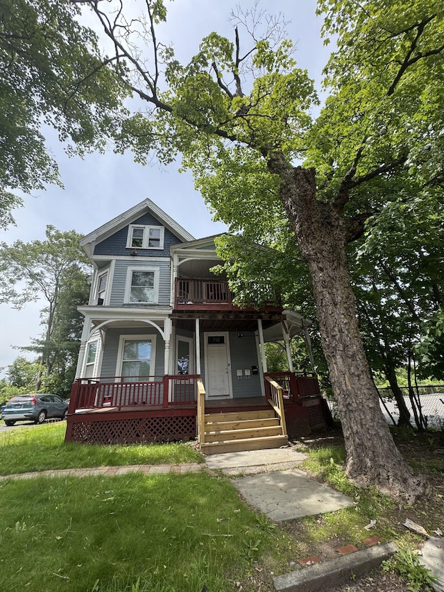 712 Stanley St, New Britain, CT 06051 - victorian-style house featuring a porch and a front lawn