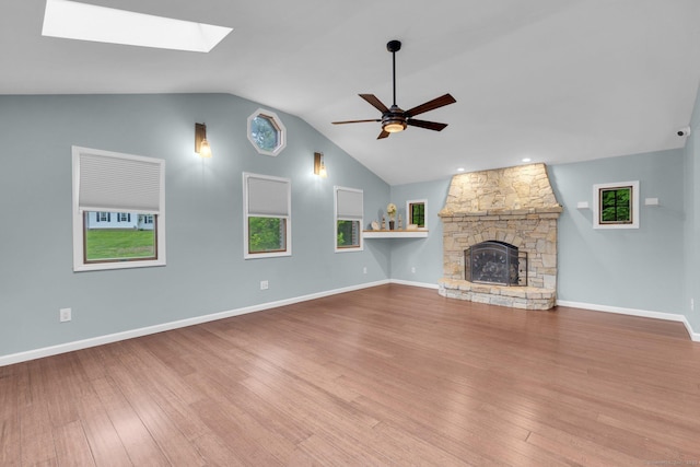 1190 Peck Ln, Cheshire, CT 06410 - unfurnished living room with ceiling fan, lofted ceiling, a skylight, wood finished floors, and a fireplace