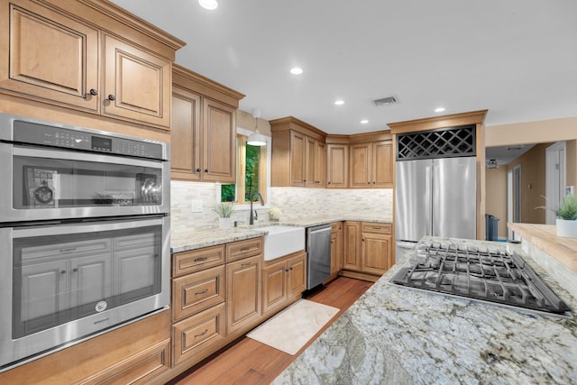 1190 Peck Ln, Cheshire, CT 06410 - kitchen featuring appliances with stainless steel finishes, a sink, light wood-type flooring, recessed lighting, and tasteful backsplash