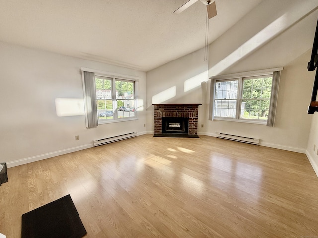 102 Beard Dr Unit 102, New Milford, CT 06776 - unfurnished living room with a baseboard heating unit, wood finished floors, a brick fireplace, a ceiling fan, and lofted ceiling