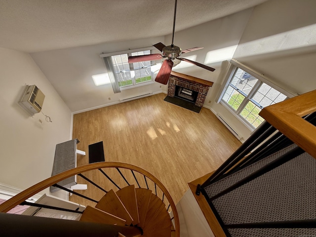 102 Beard Dr Unit 102, New Milford, CT 06776 - stairway with baseboard heating, a ceiling fan, wood finished floors, plenty of natural light, and vaulted ceiling