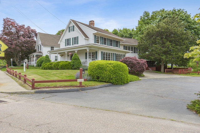 40 Holmes St, Stonington, CT 06355 - view of front of home featuring a front yard, a porch, and a chimney