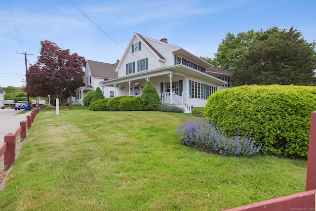 40 Holmes St, Stonington, CT 06355 - view of property exterior with a porch, a yard, and a chimney