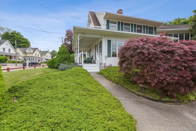 40 Holmes St, Stonington, CT 06355 - view of front of property featuring a chimney, covered porch, and a front yard
