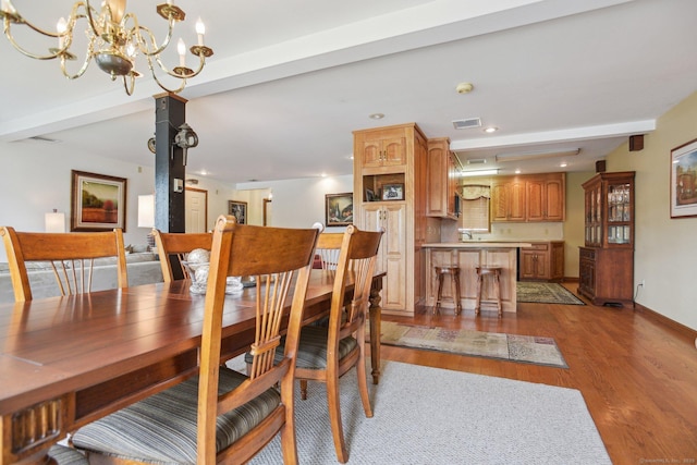 40 Holmes St, Stonington, CT 06355 - dining room with light wood-type flooring, beamed ceiling, a chandelier, recessed lighting, and baseboards