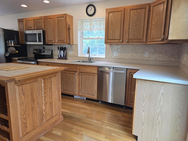 141 Grove St, Shelton, CT 06484 - kitchen featuring appliances with stainless steel finishes, light wood-style floors, decorative backsplash, recessed lighting, and brown cabinets