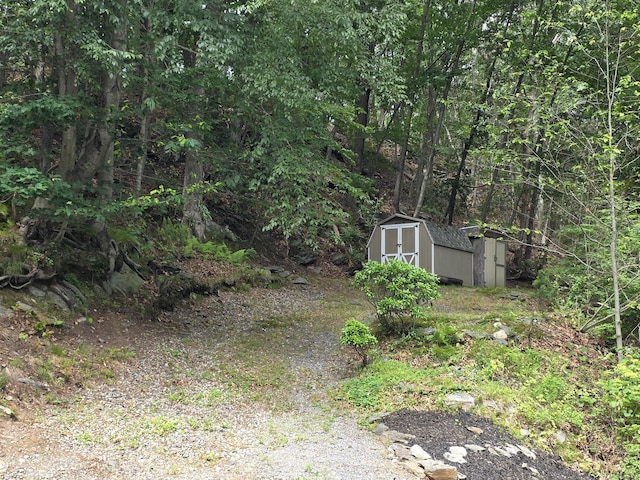141 Grove St, Shelton, CT 06484 - view of yard with a storage shed and a forest view