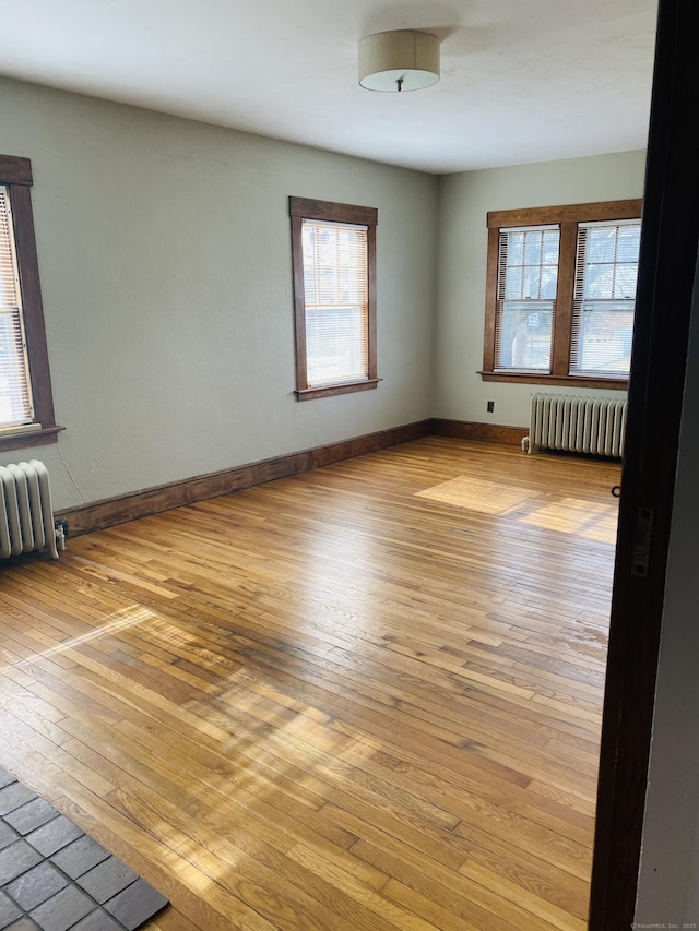 404 Center St, West Haven, CT 06516 - spare room with radiator heating unit, light wood-style floors, and plenty of natural light