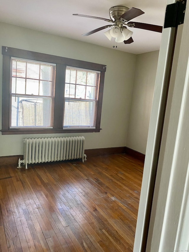 404 Center St, West Haven, CT 06516 - unfurnished room with radiator, plenty of natural light, wood-type flooring, and a ceiling fan