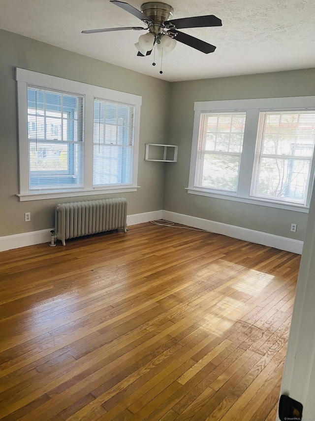 404 Center St, West Haven, CT 06516 - unfurnished room with radiator, hardwood / wood-style flooring, baseboards, and a ceiling fan