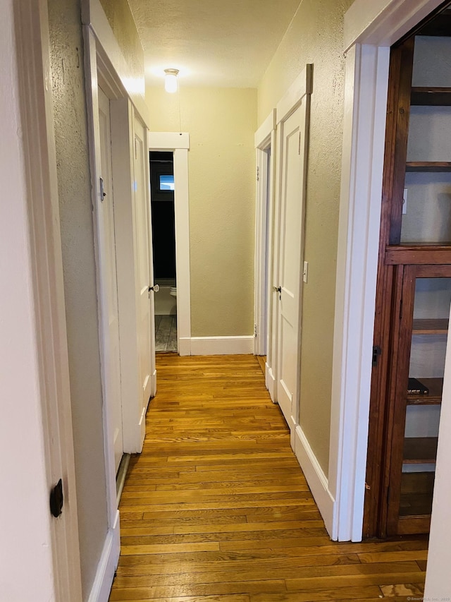 404 Center St, West Haven, CT 06516 - corridor with hardwood / wood-style floors, a textured wall, and baseboards