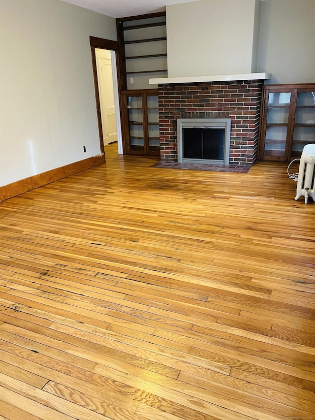 404 Center St, West Haven, CT 06516 - unfurnished living room featuring light wood-style floors and a fireplace