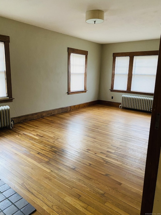 404 Center St, West Haven, CT 06516 - empty room featuring radiator heating unit, wood-type flooring, and baseboards