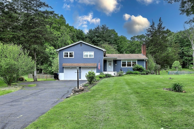 1690 Hartford Tpke, North Haven, CT 06473 - tri-level home featuring an attached garage, a chimney, and driveway