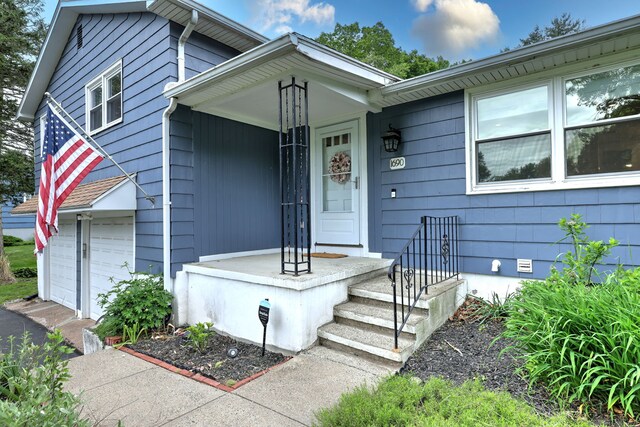 1690 Hartford Tpke, North Haven, CT 06473 - view of front facade with a garage, asphalt driveway, and crawl space